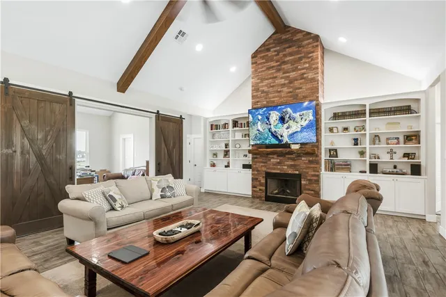 a living room with furniture and a fireplace