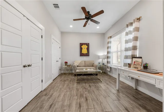 a living room with furniture and wooden floor