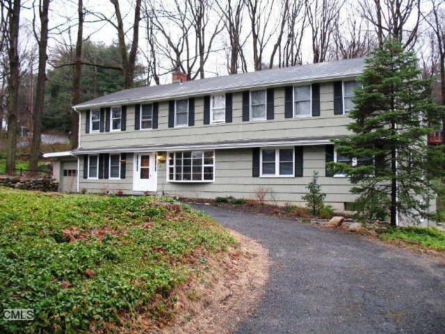 33 Christopher Road Ridgefield, CT 06877 - Photo 1 of 1 a front view of a house with a garden
