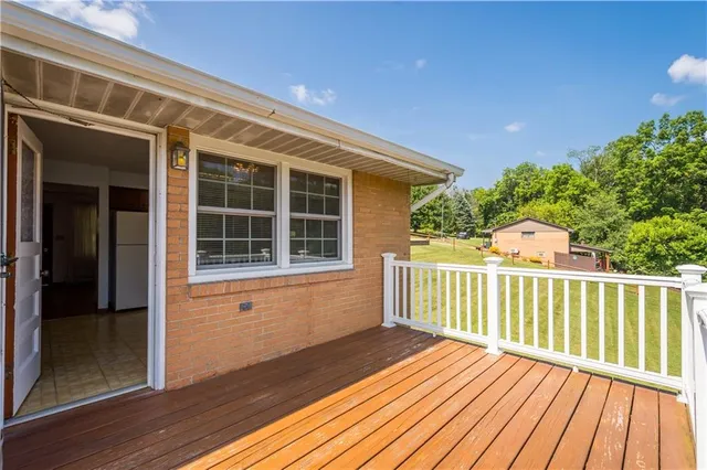 an aerial view of a house with swimming pool garden and mountain view