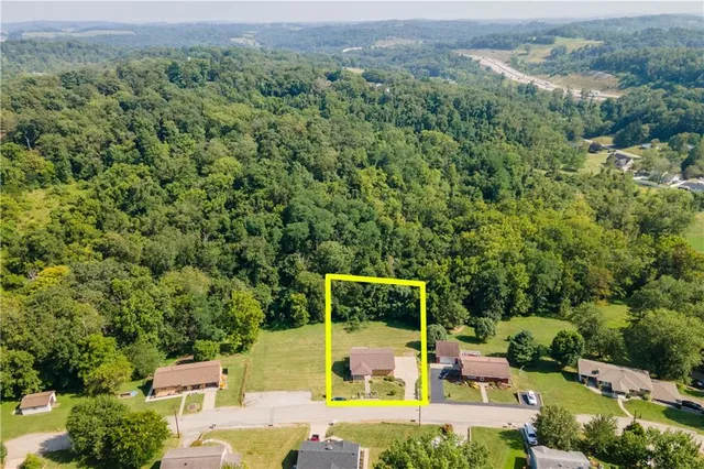 an aerial view of a house with pool outdoor seating and yard
