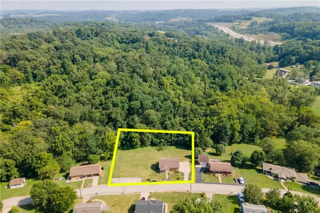 an aerial view of a houses with a yard