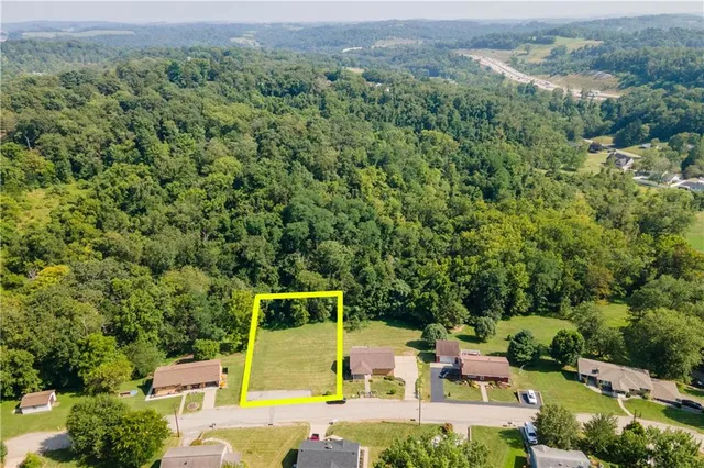 a view of a yard with an empty space and a lake view