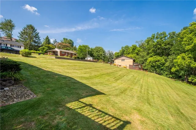 an aerial view of a house with yard