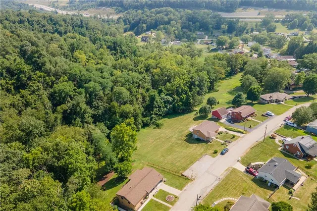 a view of a house with a backyard