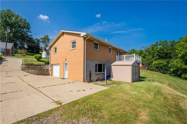 an aerial view of a house with swimming pool garden and outdoor seating