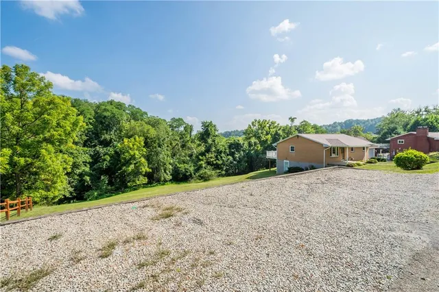 a view of an empty room and wooden floor