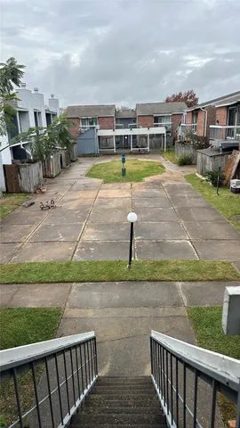a view of a swimming pool with a patio and a yard
