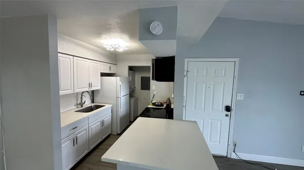 a kitchen with cabinets and a stove