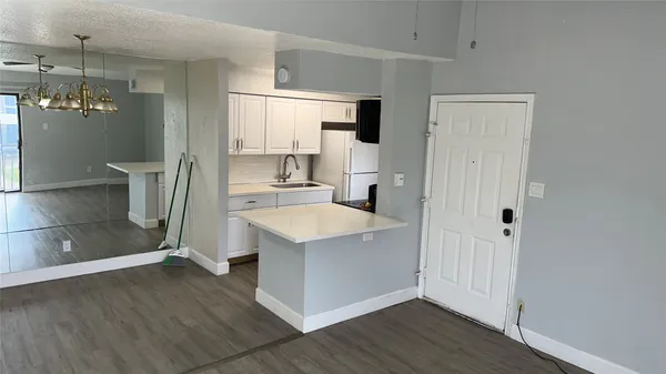 a view of a kitchen cabinets a sink and wooden floor