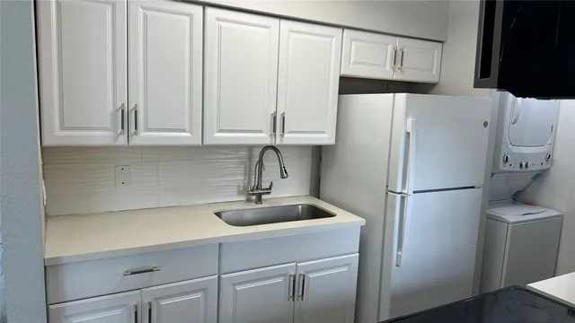 a white refrigerator freezer sitting in a kitchen