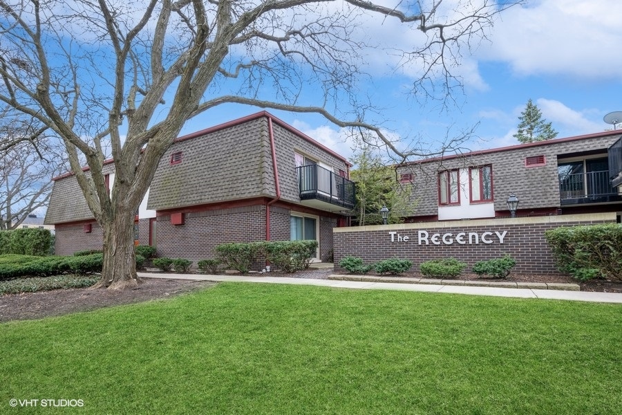 a view of a brick house with a yard