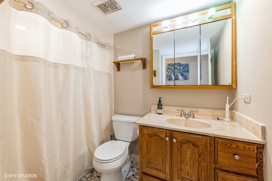 1001 Deerfield Road, Unit 204 Deerfield, IL 60015 - Photo 12 of 20 a bathroom with a sink vanity mirror and toilet
