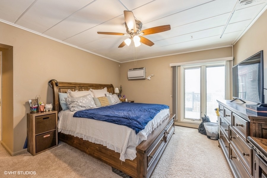 1001 Deerfield Road, Unit 204 Deerfield, IL 60015 - Photo 16 of 20 a bedroom with a bed and a chandelier