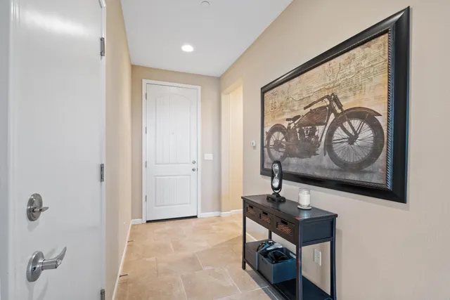 a living room with furniture a flat screen tv and a large window