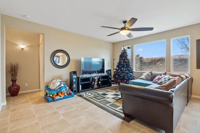 a living room with stainless steel appliances kitchen island granite countertop furniture a rug kitchen view and a chandelier