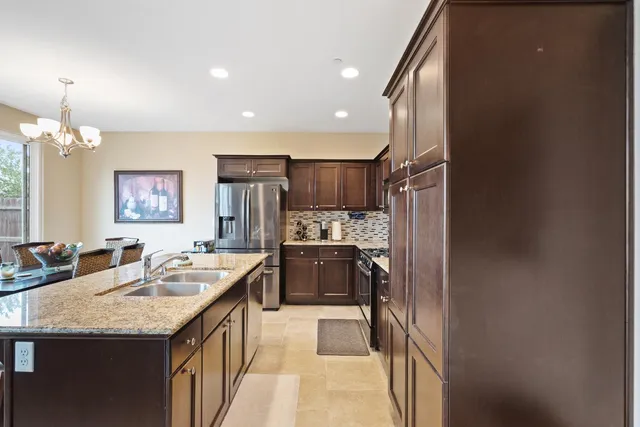 a kitchen that has a table and chairs in it