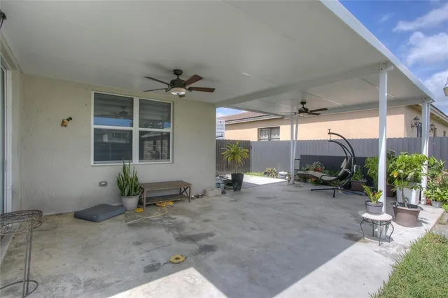 a view of a room with gym equipment and potted plants