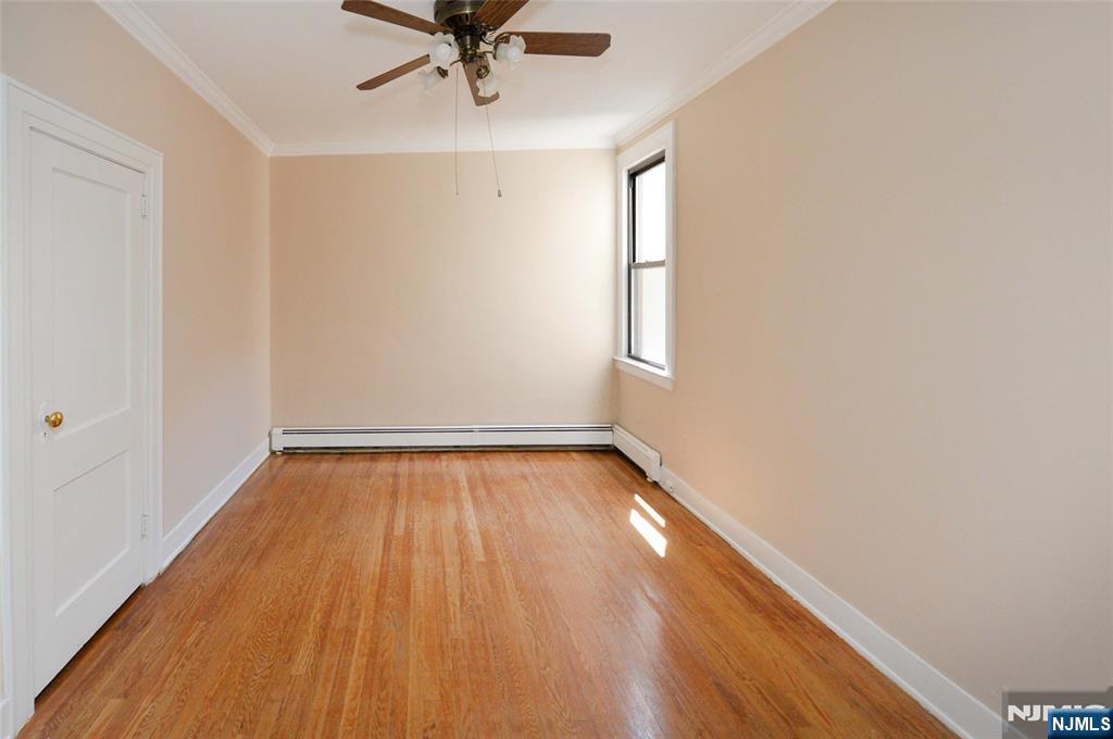 38 River Edge Road, Unit 40B River Edge, NJ 07661 - Photo 2 of 11 wooden floor in an empty room with a window