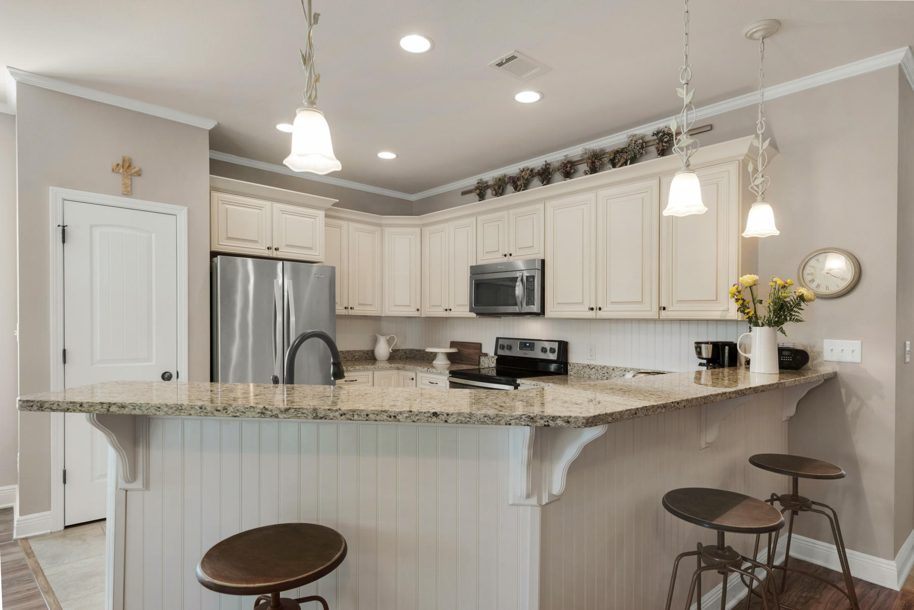 6031 Hidden Valley Road Crestview, FL 32539 - Photo 14 of 41 a kitchen with stainless steel appliances granite countertop a sink a stove a refrigerator cabinets and chairs