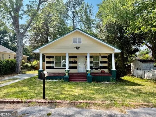 a front view of a house with a yard table and chairs