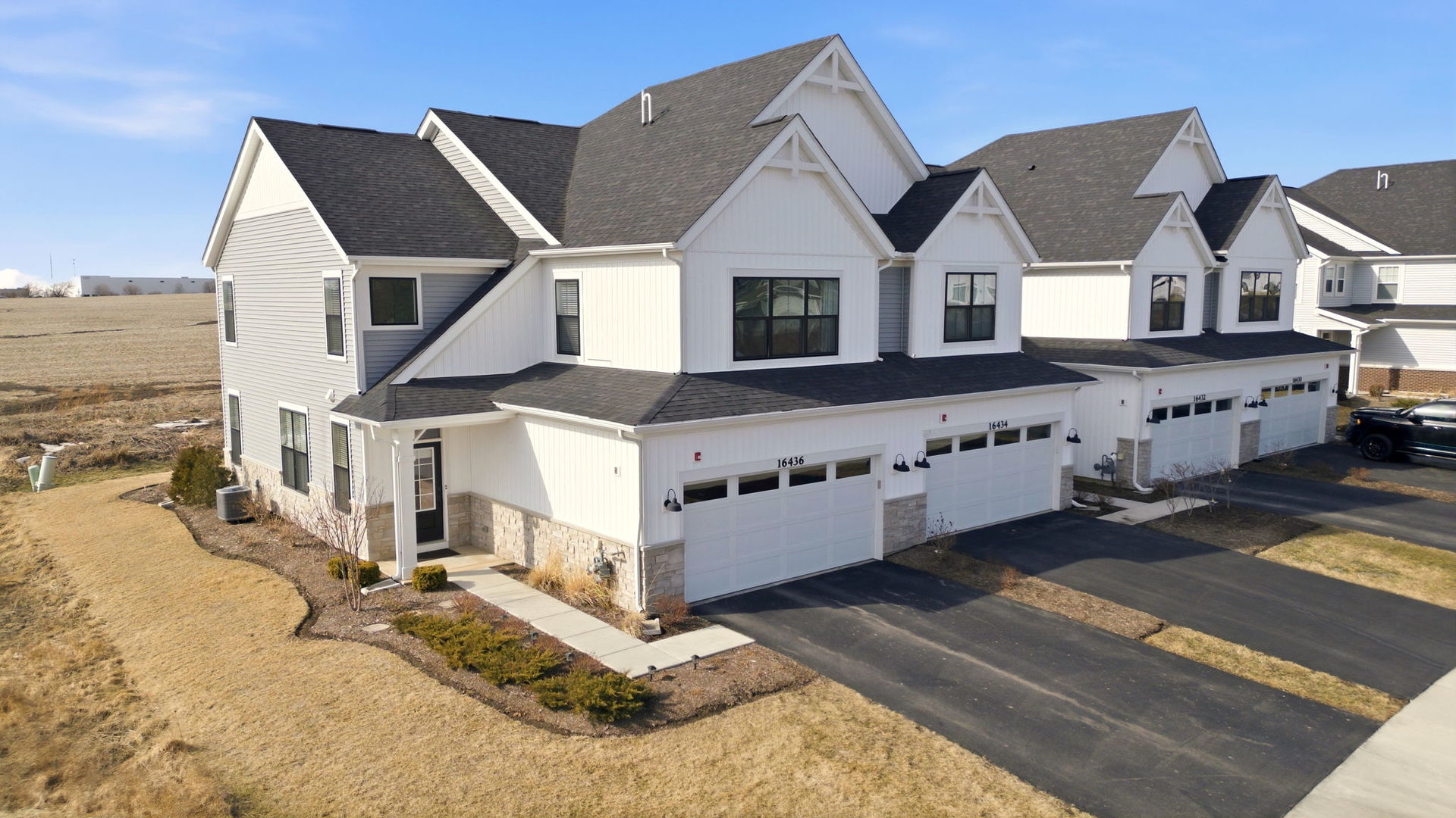 16436 Wheatgrass Street Lockport, IL 60441 - Photo 18 of 23 a view of a large white house with wooden fence