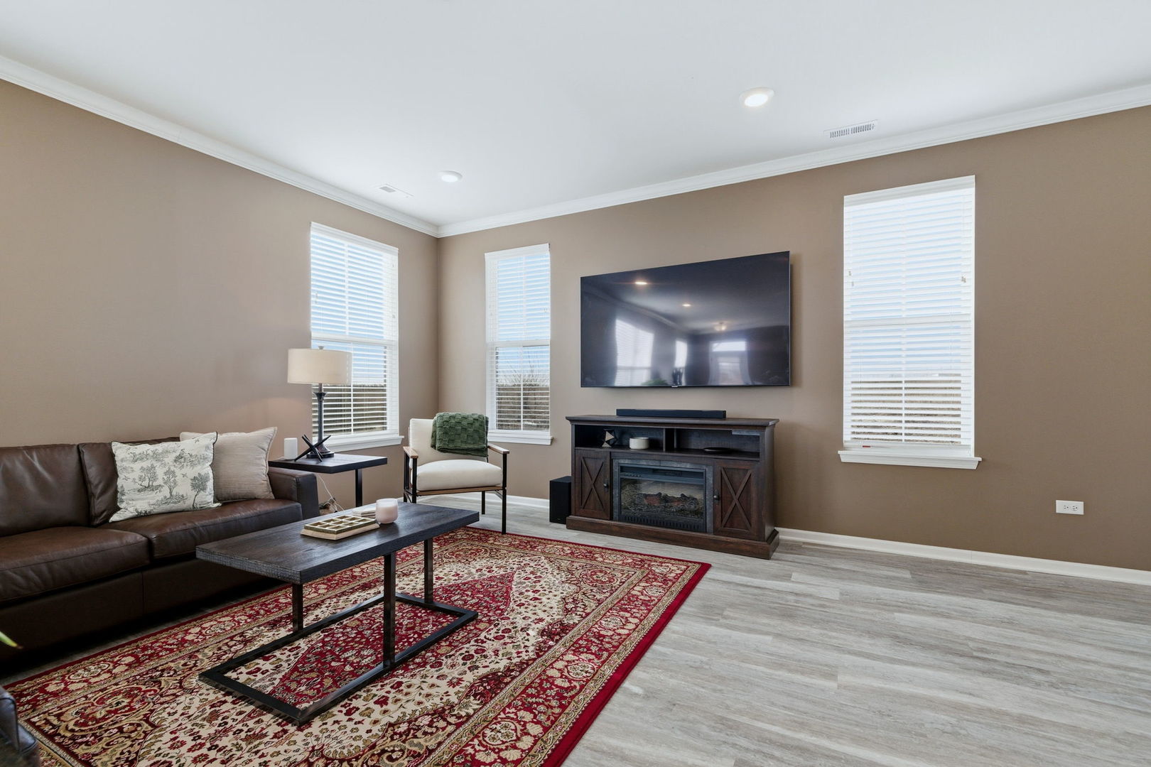 16436 Wheatgrass Street Lockport, IL 60441 - Photo 4 of 23 a living room with furniture and a flat screen tv