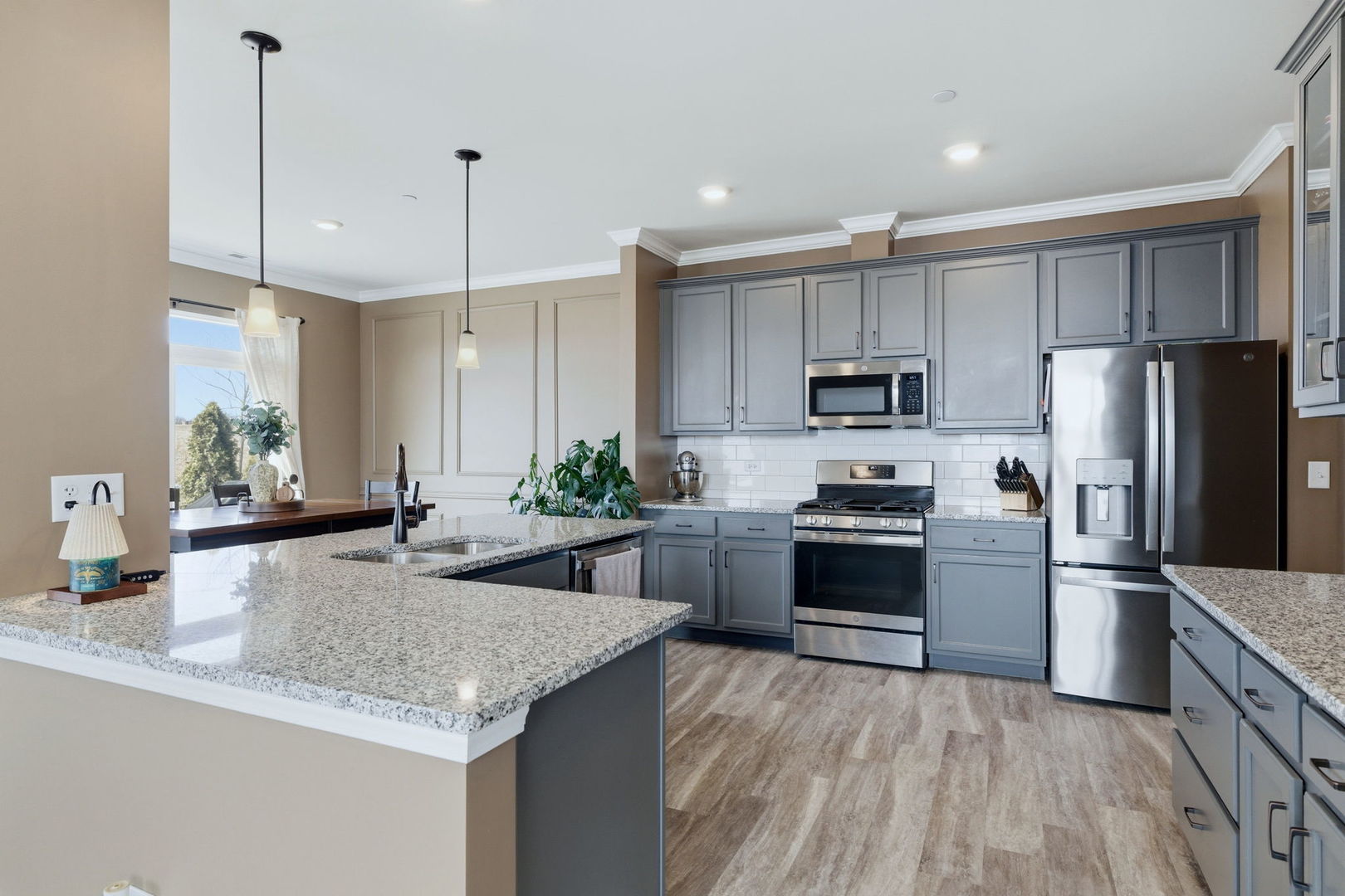 16436 Wheatgrass Street Lockport, IL 60441 - Photo 6 of 23 a kitchen with kitchen island granite countertop stainless steel appliances and a counter space