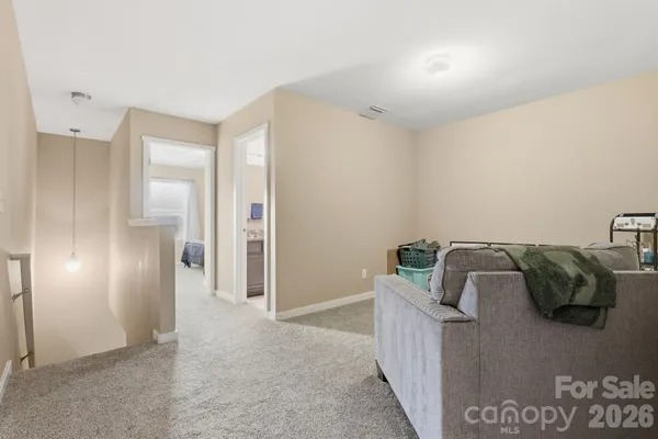 a living room with furniture and a walk in closet