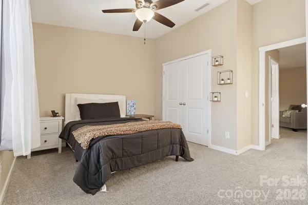 a bedroom with a bed and a ceiling fan