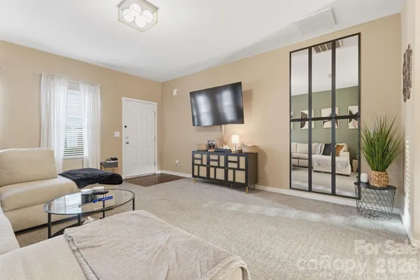 a living room with furniture and a floor to ceiling window