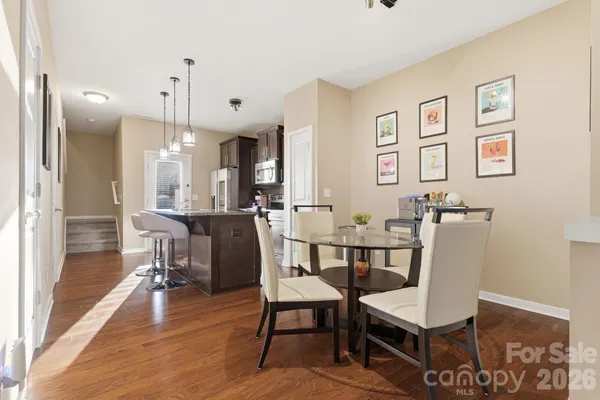 a view of a dining room with furniture and wooden floor