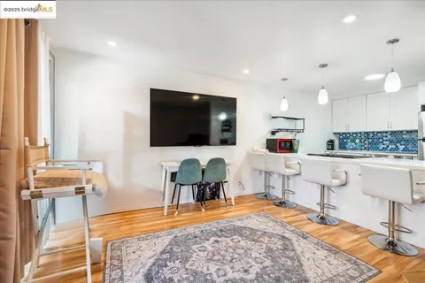 a kitchen with a refrigerator and white cabinets
