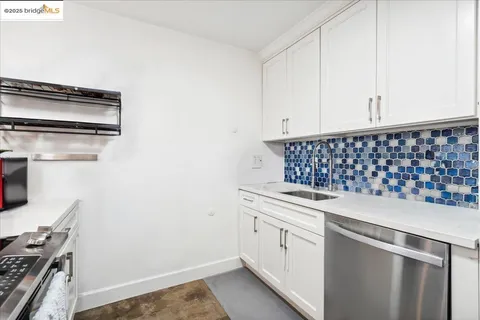 a close view of a sink a counter space and cabinets