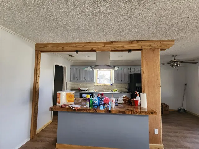 a view of storage utility room and wooden floor