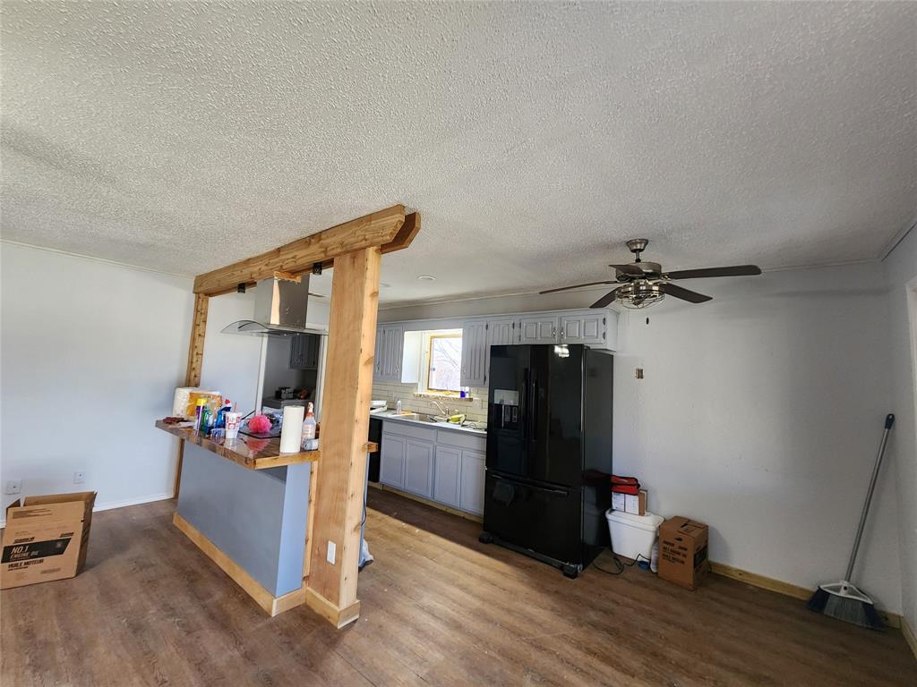 803 10th Street Princeton, TX 75407 - Photo 4 of 12 a kitchen with stainless steel appliances wooden floor and chair