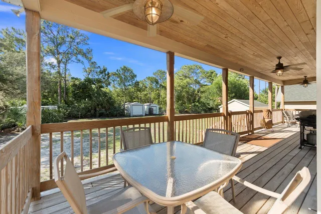 a view of a chairs and table in the balcony