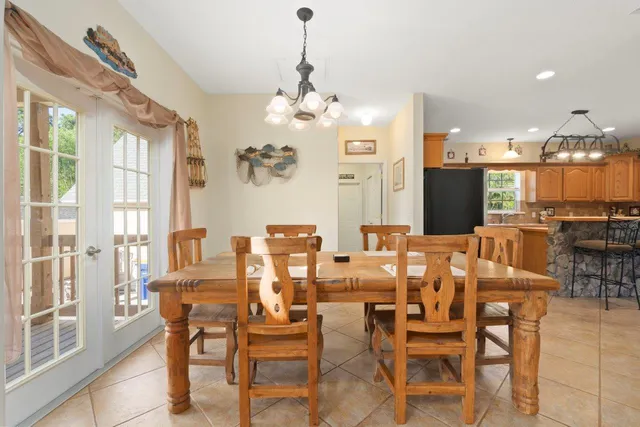 a view of a dining room with furniture and chandelier