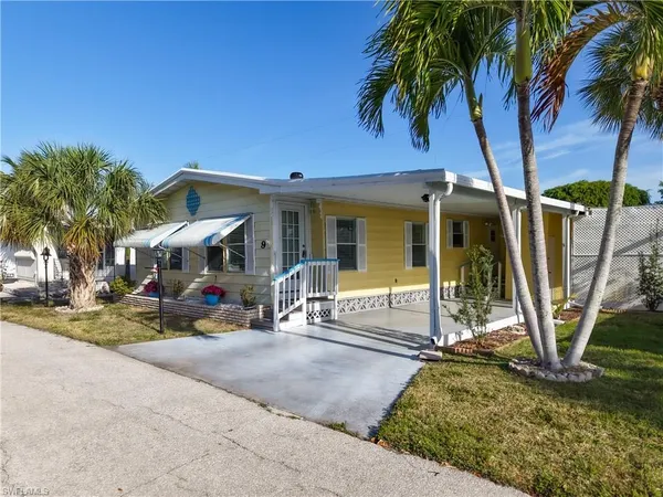 a view of a house with backyard porch and sitting area