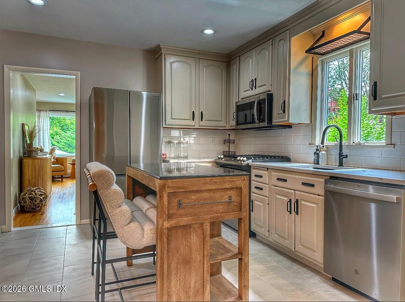37 Gerry Street Greenwich, CT 06830 - Photo 4 of 14 a kitchen with stainless steel appliances granite countertop a stove a sink dishwasher a microwave oven and a refrigerator with wooden cabinets