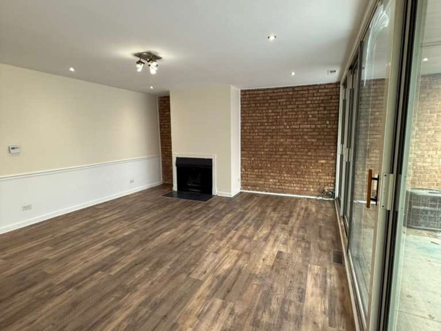 5900 Forest View Road, Unit 1A Lisle, IL 60532 - Photo 3 of 12 a view of an empty room with wooden floor and a window