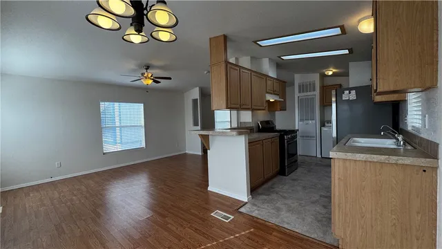 a kitchen with a refrigerator and a stove top oven