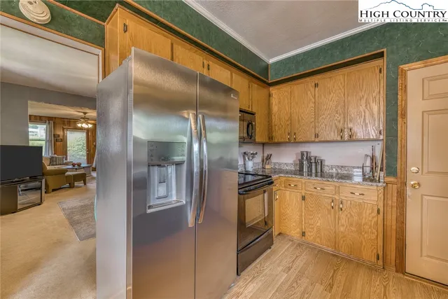 a kitchen with stainless steel appliances a refrigerator sink and cabinets