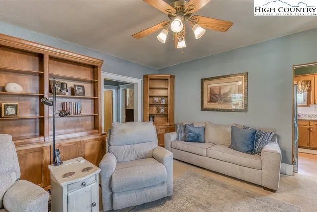 a living room with furniture and a bookshelf