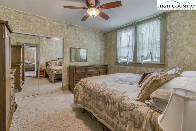 a spacious bedroom with a bed and ceiling fan