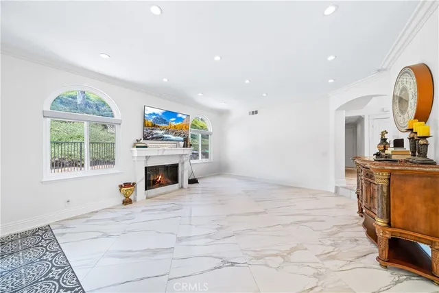 a view of living room with furniture and a fireplace