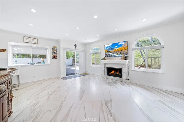 a living room with furniture a fireplace and a flat screen tv