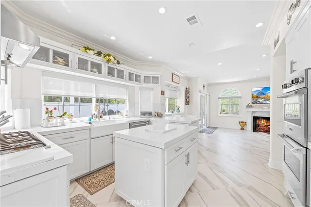 a kitchen with stainless steel appliances a refrigerator sink and cabinets