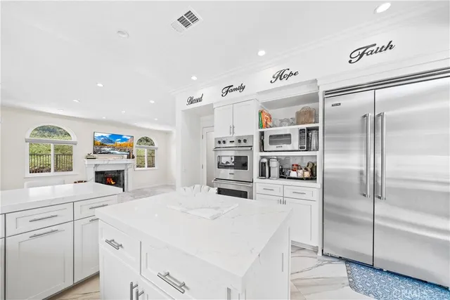 a kitchen with stainless steel appliances a stove refrigerator sink and cabinets