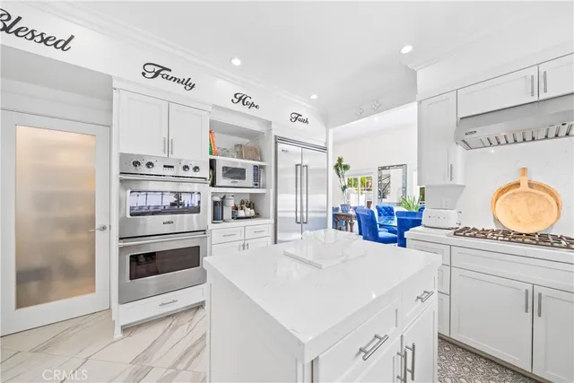 a kitchen with a stove a sink and a wooden cabinets